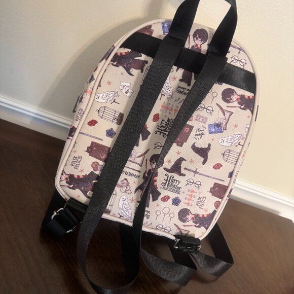 harry potter hogwarts icons mini backpack Hogwarts™ Crest The middle pocket features Harry Potter and the Goblet of Fire Harry Potter Snowy Hogwarts Scene